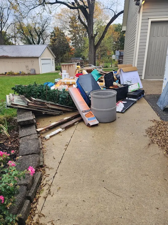 Dumpster being loaded with debris for 12 Yard Dumpster Rental in Owasso